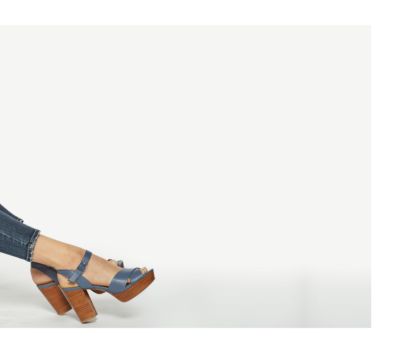 Row of assorted print and pastel pants folded at the knee