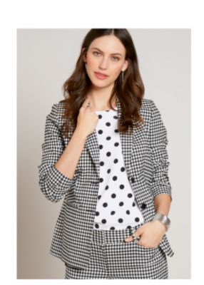 Model in white floral print dress with ruched sleeves & ruffle hem. 